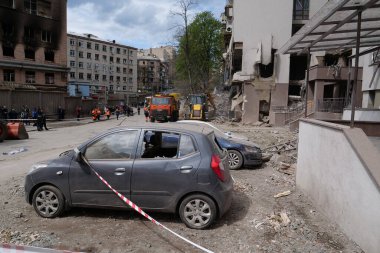 KYIV, UKRAINE, APRIL 29, 2022: After bombing. Cars near dwelling house damaged by russian missile on April 28, 2022. Russian aggression. War in Ukraine. Terror and genocide of Ukrainian people