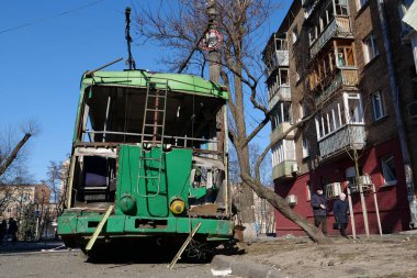 UKRAINE, KYIV, MARCH 20, 2022: Russian missile destroyed trolleybus and houses in Kyiv on March 14, 2022. After bombing. War in Ukraine. Terror and genocide of Ukrainian people