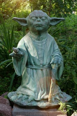 KYIV, UKRAINE, 16 Temmuz 2022: Usta Yoda 'nın heykeli - Yıldız Savaşları' nda kapalı gözlerle meditasyon yapan kurgusal karakter, Kyiv 'in merkez botanik bahçesinde yer almaktadır. Güç seninle olsun.