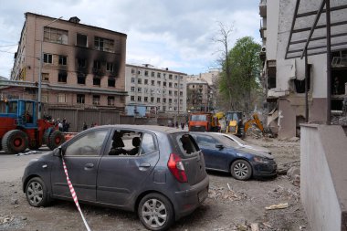 KYIV, UKRAINE, APRIL 29, 2022: After bombing. Cars near dwelling house damaged by russian missile on April 28, 2022. Russian aggression. War in Ukraine. Terror and genocide of Ukrainian people