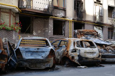 IRPIN, UKRAINE, JUNE 6, 2022: After bombing. Russian terrorist army burned cars, dwelling houses and killed people in Irpin town, Kyiv Oblast on March 2022. Terror and genocide of Ukrainian people