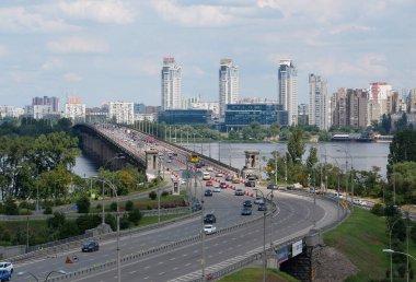 KYIV, UKRAINE, JULY 16, 2022: View of Paton Bridge and left bank of Dnieper river in Kyiv city, Ukraine