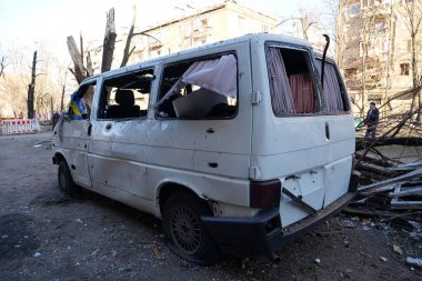 KYIV, UKRAINE, MARCH 20, 2022: Russian missile destroyed minibus and damaged houses in Kyiv on March 18, 2022.Russian aggression, after bombing, war in Ukraine, terror and genocide of Ukrainian people