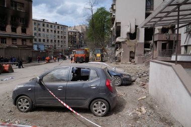 KYIV, UKRAINE, APRIL 29, 2022: After bombing. Cars near dwelling house damaged by russian missile on April 28, 2022. Russian aggression. War in Ukraine. Terror and genocide of Ukrainian people