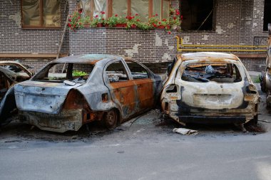 IRPIN, UKRAINE, JUNE 6, 2022: After bombing. Russian terrorist army burned cars, dwelling houses and killed people in Irpin town, Kyiv Oblast on March 2022. Terror and genocide of Ukrainian people