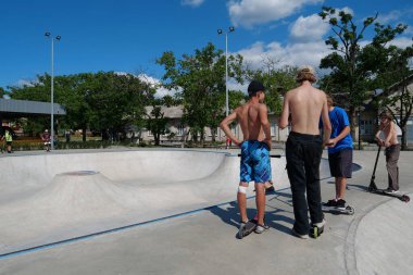 KYIV, UKRAINE, JULY 26, 2022: Childrens rides scooters at new open air sport zone at expo center of Ukraine, permanent multi-purpose exhibition complex in Teremky neighborhood of Kyiv, Ukraine