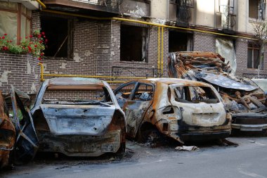 IRPIN, UKRAINE, JUNE 6, 2022: After bombing. Russian terrorist army burned cars, dwelling houses and killed people in Irpin town, Kyiv Oblast on March 2022. Terror and genocide of Ukrainian people