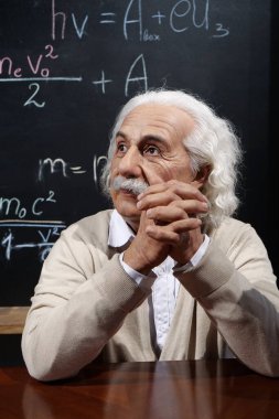 UKRAINE, BUKOVEL, OCTOBER 13, 2022: World-famous scientist, Nobel laureate, theoretical physicist, creator of theory of relativity Albert Einstein, who sits at the table