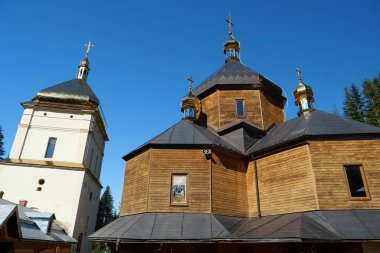 Manyava Skete of Exaltation of Holy Cross in the forest in Carpathian mountains, Ukraine. Orthodox solitary cell mens monastery, skete. Near skete in wood there is Blessed Stone, object of worship