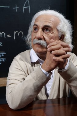 UKRAINE, BUKOVEL, OCTOBER 13, 2022: World-famous scientist, Nobel laureate, theoretical physicist, creator of theory of relativity Albert Einstein, who sits at the table