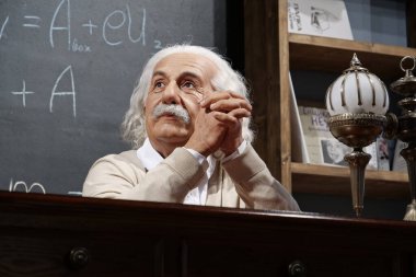 BUKOVEL, UKRAINE, OCTOBER 13, 2022: World-famous scientist, theoretical physicist, Nobel laureate, creator of theory of relativity Albert Einstein, who sits at the table