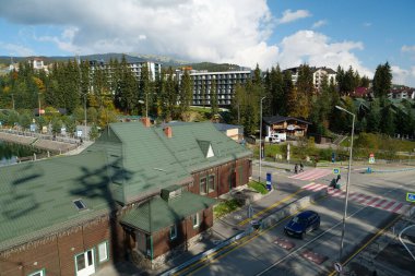 BUKOVEL, UKRAINE, OCTOBER 13, 2022: People in Bukovel - beautiful village and largest ski resort in Carpathian Mountains, Ivano-Frankivsk Oblast, western Ukraine
