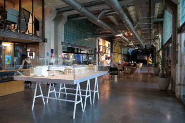 IVANO-FRANKIVSK, UKRAINE, AUGUST 20, 2022: People in coworking space PROMPRYLAD in former factory workshop. Coworking - arrangement in which workers of many companies share an office space