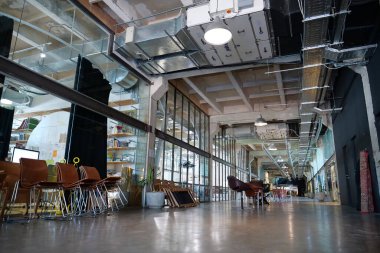 IVANO-FRANKIVSK, UKRAINE, AUGUST 20, 2022: People in coworking space PROMPRYLAD in former factory workshop. Coworking - arrangement in which workers of many companies share an office space