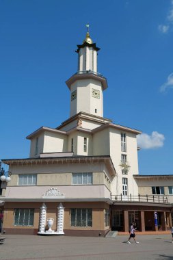 IVANO-FRANKIVSK, UKRAINE, AUGUST 21, 2022: People near Ratusha or Town Hall in Ivano-Frankivsk city, Ukraine. Building in art deco style in center of Ivano-Frankivsk city on Rynok or Market Square