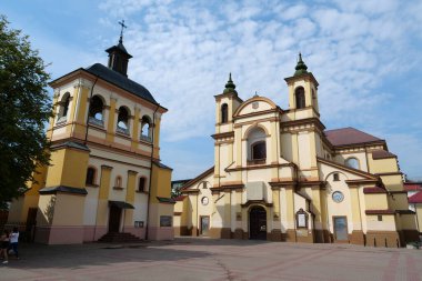 IVANO-FRANKIVSK, UKRAINE, AUGUST 22, 2022: People near Church of the Blessed Virgin Mary, an now art museum on Sheptitskogo Square in Ivano-Frankivsk city, western Ukraine