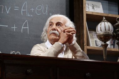 BUKOVEL, UKRAINE, OCTOBER 13, 2022: World-famous scientist, theoretical physicist, Nobel laureate, creator of theory of relativity Albert Einstein, who sits at the table