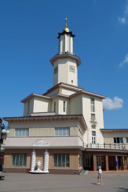 IVANO-FRANKIVSK, UKRAINE, AUGUST 21, 2022: People near Ratusha or Town Hall in Ivano-Frankivsk city, Ukraine. Building in art deco style in center of Ivano-Frankivsk city on Rynok or Market Square