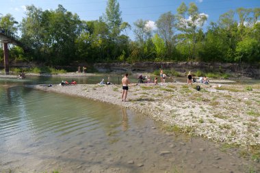 IVANO-FRANKIVSK, UKRAINE, AUGUST 19, 2022: People rests by river in Ivano-Frankivsk city in western Ukraine