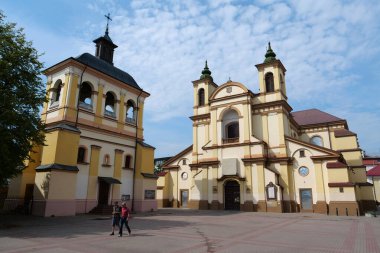 IVANO-FRANKIVSK, UKRAINE, AUGUST 22, 2022: People near Church of the Blessed Virgin Mary, an now art museum on Sheptitskogo Square in Ivano-Frankivsk city, western Ukraine