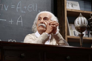 BUKOVEL, UKRAINE, OCTOBER 13, 2022: World-famous scientist, theoretical physicist, Nobel laureate, creator of theory of relativity Albert Einstein, who sits at the table
