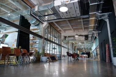 IVANO-FRANKIVSK, UKRAINE, AUGUST 20, 2022: People in coworking space PROMPRYLAD in former factory workshop. Coworking - arrangement in which workers of many companies share an office space