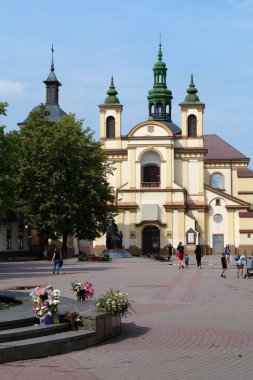 IVANO-FRANKIVSK, UKRAINE, AUGUST 22, 2022: People near Church of the Blessed Virgin Mary, an now art museum on Sheptitskogo Square in Ivano-Frankivsk city, western Ukraine