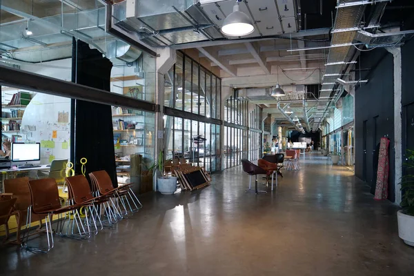 IVANO-FRANKIVSK, UKRAINE, AUGUST 20, 2022: People in coworking space PROMPRYLAD in former factory workshop. Coworking - arrangement in which workers of many companies share an office space