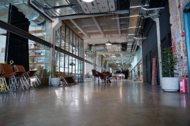 IVANO-FRANKIVSK, UKRAINE, AUGUST 20, 2022: People in coworking space PROMPRYLAD in former factory workshop. Coworking - arrangement in which workers of many companies share an office space