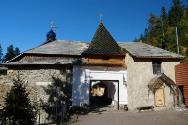 Manyava Skete of Exaltation of Holy Cross in the forest in Carpathian mountains, Ukraine. Orthodox solitary cell mens monastery, skete. Near skete in wood there is Blessed Stone, object of worship