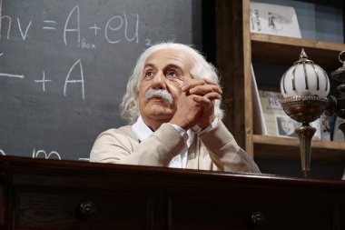 BUKOVEL, UKRAINE, OCTOBER 13, 2022: World-famous scientist, theoretical physicist, Nobel laureate, creator of theory of relativity Albert Einstein, who sits at the table