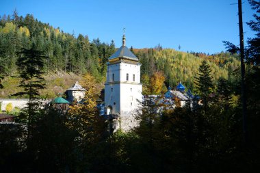 Manyava Skete of Exaltation of Holy Cross in forest in Carpathian mountains, Ukraine. Orthodox solitary cell mens monastery, skete. Near skete in the wood there is Blessed Stone, object of worship