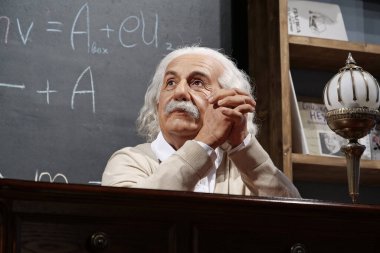 BUKOVEL, UKRAINE, OCTOBER 13, 2022: World-famous scientist, theoretical physicist, Nobel laureate, creator of theory of relativity Albert Einstein, who sits at the table