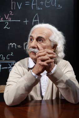 UKRAINE, BUKOVEL, OCTOBER 13, 2022: World-famous scientist, Nobel laureate, theoretical physicist, creator of theory of relativity Albert Einstein, who sits at the table