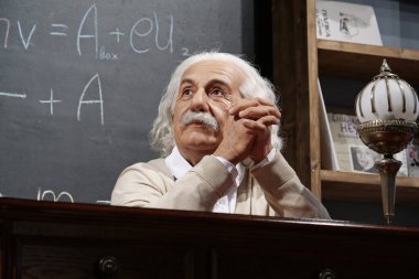BUKOVEL, UKRAINE, OCTOBER 13, 2022: World-famous scientist, theoretical physicist, Nobel laureate, creator of theory of relativity Albert Einstein, who sits at the table