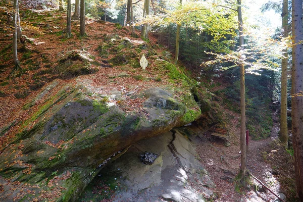 stock image Blessed Stone and sacred spring in the forest near Manyava Skete in Western Ukraine, regarded as a place of prayer and of spiritual purification. Spring of healing water emits from underneath it