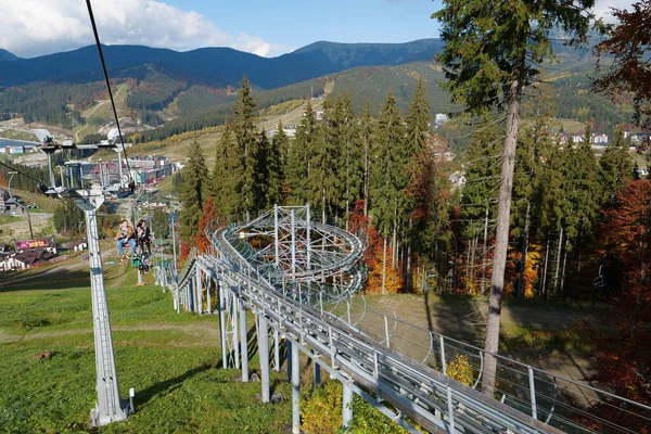 stock image BUKOVEL, UKRAINE, OCTOBER 13, 2022: People on ski lift in Bukovel - beautiful village and largest ski resort in Carpathian Mountains, Ivano-Frankivsk Oblast, western Ukraine