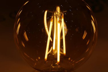 Light bulbs with big yellow filaments inside in vintage style clipart