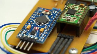 Elektronik tamir. Yanan kırmızı LED ampullü küçük bir elektronik devre. Elektronik bileşenleri güç kaynağına bağlı olan mikro devre. Mikrodevre, rezistanslar ve çipler