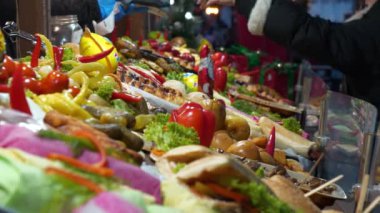 KYIV, UKRAINE, HAZİRAN 6, 2024: İnsanlar bir sokak büfesinden yiyecek ve içecek alıyor. Akıllı telefondan kredi kartıyla ödeme. Yemek satıyorum.