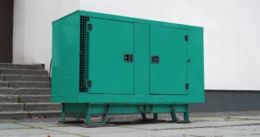 Binaya bağlı yeşil dizel motorlu jeneratör. Elektrik santrali bağımsız, tam teşekküllü bir güç üretim cihazı ve sistemidir. Elektrik enerjisinin kaynağı. Sinema 4K 60fps yakınlaştırma videosu