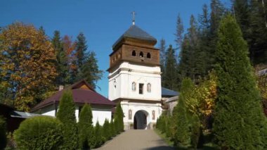 Inner courtyard of Manyava Skete of Exaltation of Holy Cross in Carpathian mountains, Ukraine. Orthodox solitary cell mens monastery, skete.Near skete in wood there is Blessed Stone, object of worship
