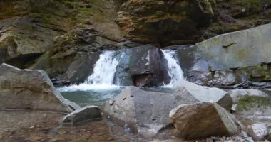 Dağlarda küçük güzel bir şelale, sesli bir video.