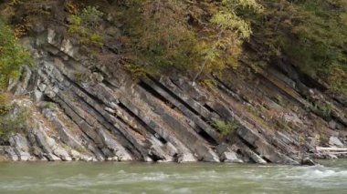 Mountain river with rapid current. The Prut river and mountain folds in Yaremche City, Carpathians, western Ukraine