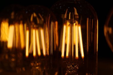 Light bulbs with big yellow filaments inside in vintage style clipart