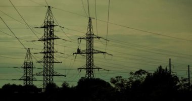 Zaman ayarlı Güç iletim kuleleri ve akşam bulutları