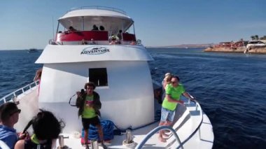 EGYPT, SINAI, SHARM EL SHEIKH, DECEMBER 7, 2019: People on pleasure boat in Red Sea near coast of Sharm El Sheikh city