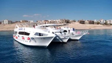 EGYPT, SINAI, SHARM EL SHEIKH, RED SEA, DECEMBER 7, 2019: Three white pleasure boats in Red Sea near coast of Sharm El Sheikh city in Egypt