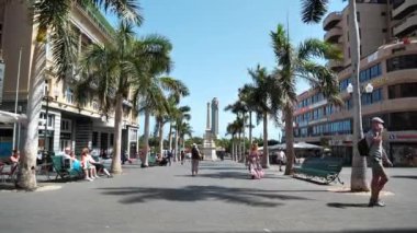 SANTA CRUZ DE TENERIFE, CANARY ISLANDS, SPAIN, SEPTEMBER 28, 2019: People near Triunfo de la Candelaria or obelisk of La Candelaria, Plaza de la Candelaria in Santa Cruz de Tenerife, Canary islands