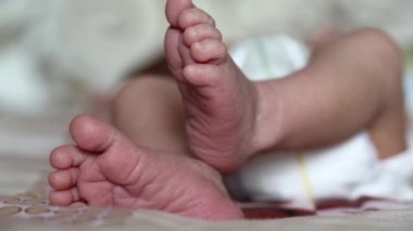 Yeni doğmuş bebeğin ayakları. Üç haftalık neonatal 'ın komik ayakları.